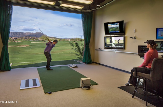 recreation room with carpet floors, golf simulator, and a mountain view