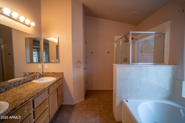 full bathroom featuring double vanity, a sink, tile patterned flooring, a shower stall, and a bath