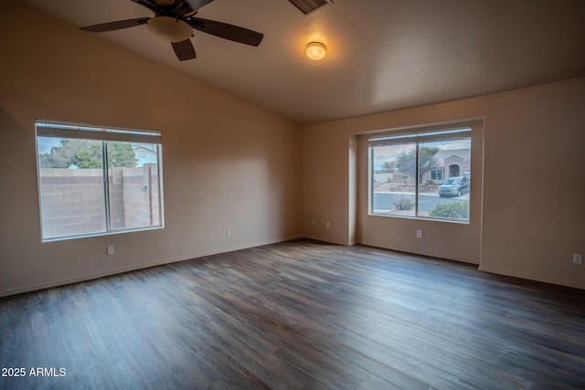 unfurnished room featuring ceiling fan, baseboards, wood finished floors, and vaulted ceiling