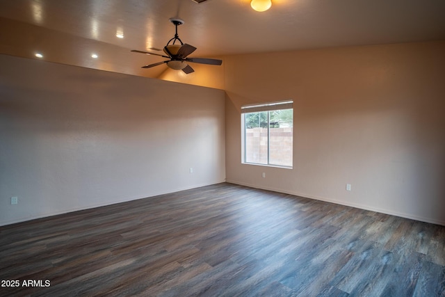 empty room with dark wood-style floors, lofted ceiling, and ceiling fan