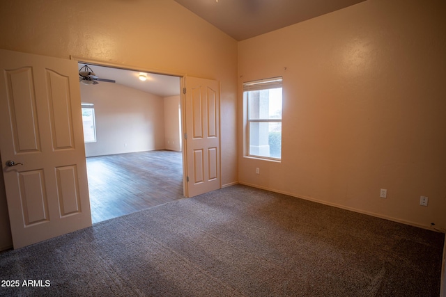 carpeted empty room with ceiling fan and vaulted ceiling