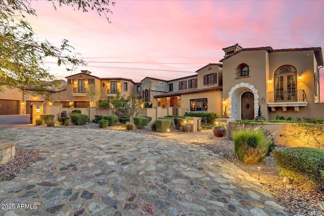 mediterranean / spanish-style house featuring fence and stucco siding