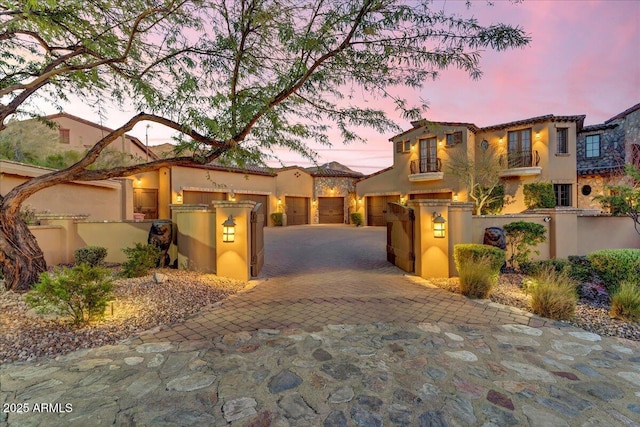 10935 E Grandview Way, Scottsdale, AZ 85255 - mediterranean / spanish-style home with decorative driveway, fence, an attached garage, and stucco siding