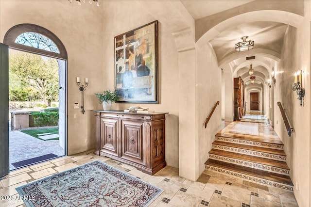 10935 E Grandview Way, Scottsdale, AZ 85255 - foyer featuring arched walkways, stone tile flooring, and a towering ceiling