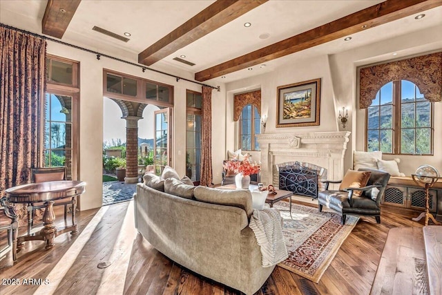 10935 E Grandview Way, Scottsdale, AZ 85255 - living area with decorative columns, visible vents, hardwood / wood-style flooring, a fireplace, and beam ceiling