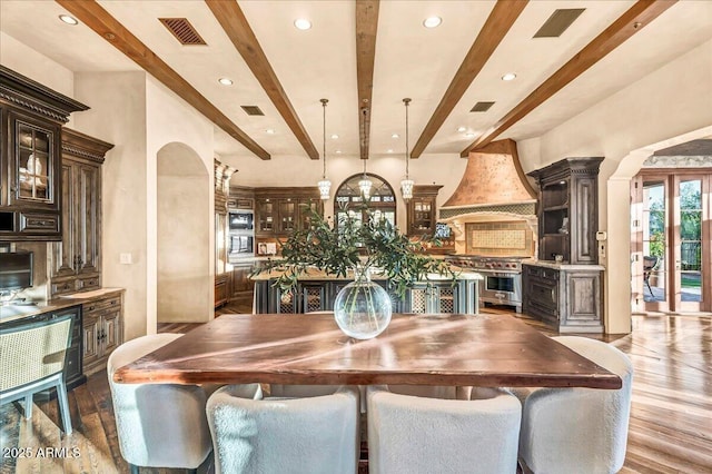 10935 E Grandview Way, Scottsdale, AZ 85255 - dining space featuring arched walkways, visible vents, beamed ceiling, and wood finished floors