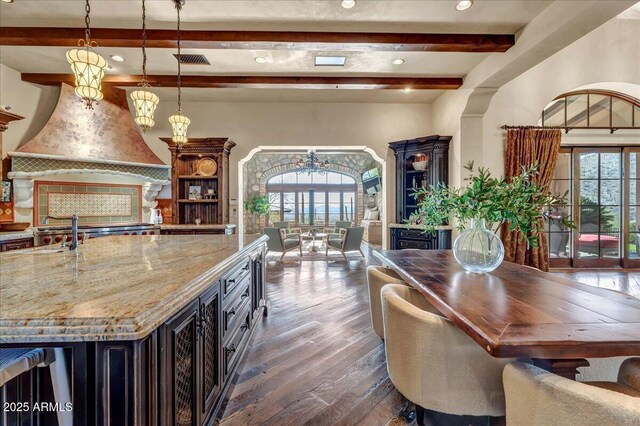 10935 E Grandview Way, Scottsdale, AZ 85255 - kitchen with visible vents, dark wood finished floors, custom range hood, light stone countertops, and beam ceiling