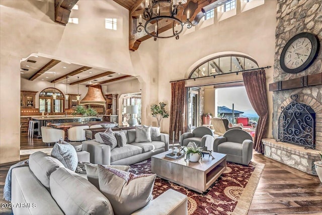 10935 E Grandview Way, Scottsdale, AZ 85255 - living area with a wealth of natural light, a brick fireplace, beamed ceiling, and wood finished floors