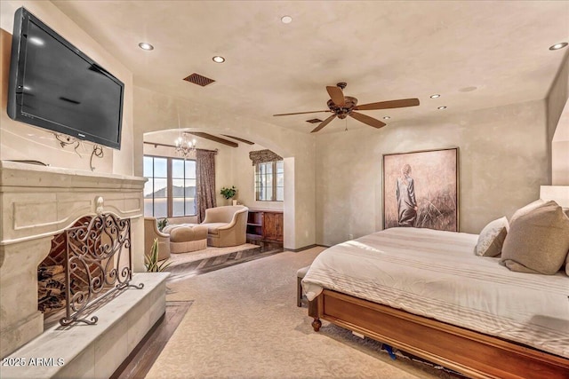 10935 E Grandview Way, Scottsdale, AZ 85255 - carpeted bedroom with arched walkways, a fireplace with raised hearth, visible vents, and recessed lighting