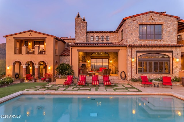 10935 E Grandview Way, Scottsdale, AZ 85255 - back of property with a tile roof, a patio area, an outdoor pool, and a balcony