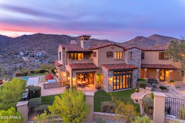 10935 E Grandview Way, Scottsdale, AZ 85255 - mediterranean / spanish house featuring a fenced front yard, a patio, an outdoor kitchen, and a mountain view