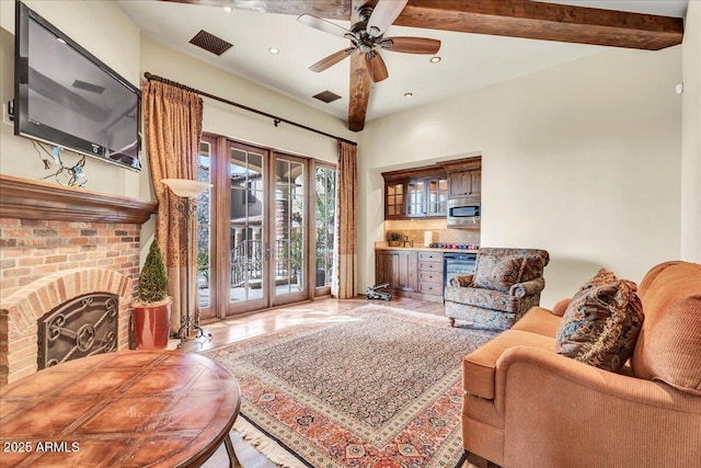 10935 E Grandview Way, Scottsdale, AZ 85255 - living area featuring a brick fireplace, visible vents, beamed ceiling, and french doors