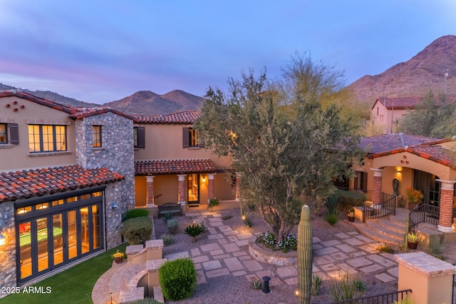 10935 E Grandview Way, Scottsdale, AZ 85255 - exterior space featuring stone siding, a tile roof, a mountain view, and a patio