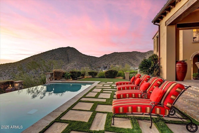 10935 E Grandview Way, Scottsdale, AZ 85255 - pool at dusk with an infinity pool, a patio area, and a mountain view