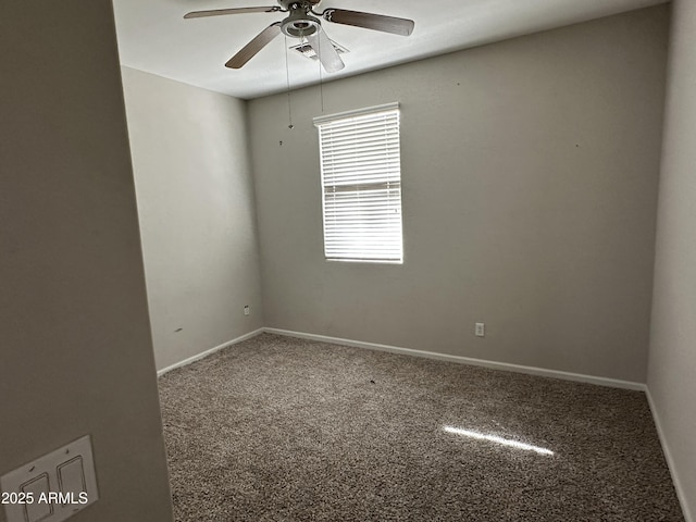 empty room with ceiling fan and carpet