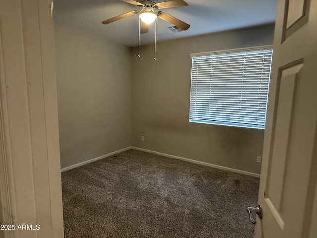 carpeted spare room with ceiling fan