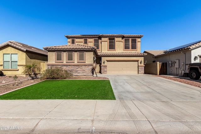 mediterranean / spanish-style home featuring a garage and a front yard