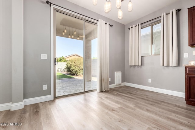 interior space with an inviting chandelier and light wood-type flooring