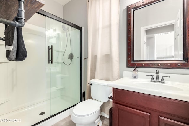 bathroom featuring vanity, toilet, and walk in shower