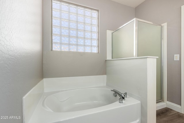 bathroom with hardwood / wood-style flooring and plus walk in shower