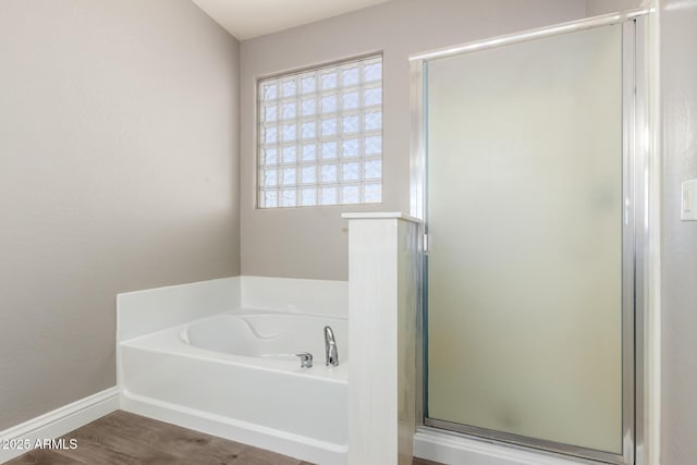 bathroom featuring hardwood / wood-style floors and independent shower and bath