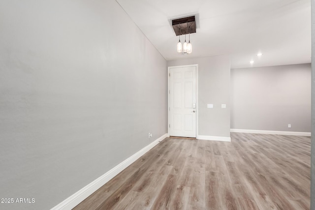 empty room with light hardwood / wood-style flooring