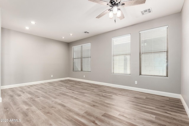 empty room with light hardwood / wood-style flooring and ceiling fan