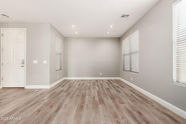 empty room with light hardwood / wood-style floors