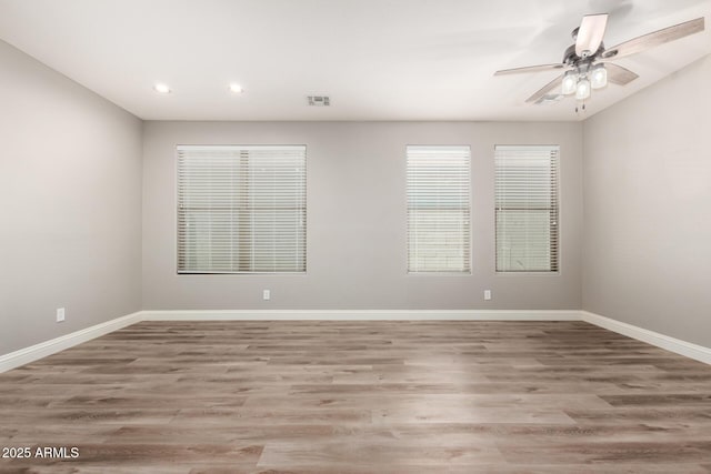 unfurnished room featuring light hardwood / wood-style flooring and ceiling fan