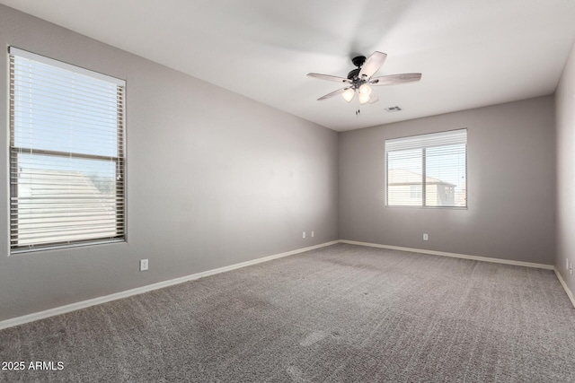 spare room with carpet and ceiling fan