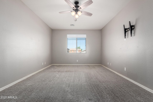 spare room featuring carpet flooring and ceiling fan