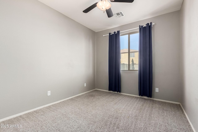 carpeted spare room featuring ceiling fan