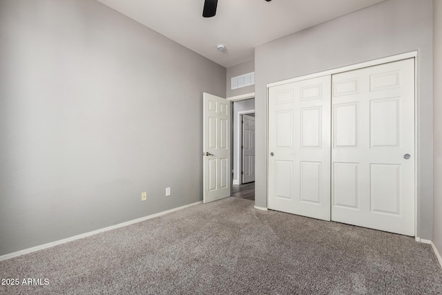 unfurnished bedroom with carpet flooring, ceiling fan, and a closet