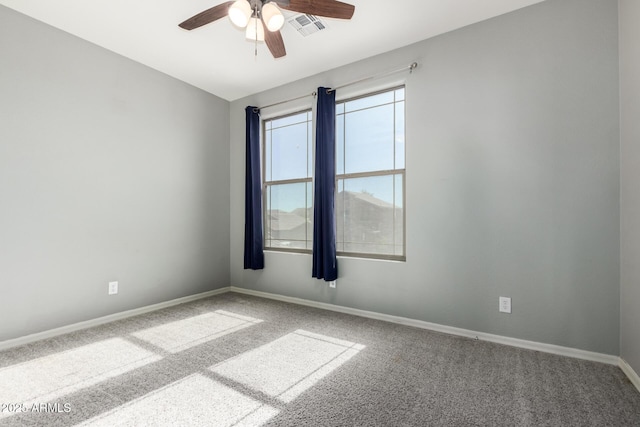 carpeted empty room featuring ceiling fan