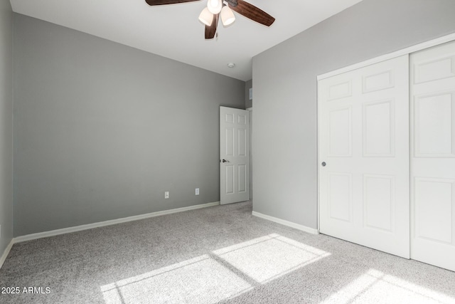 unfurnished bedroom featuring ceiling fan, carpet flooring, and a closet