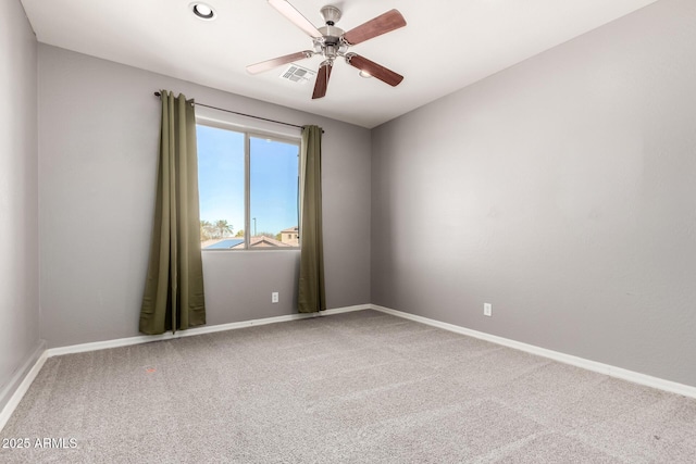 spare room featuring ceiling fan and carpet floors