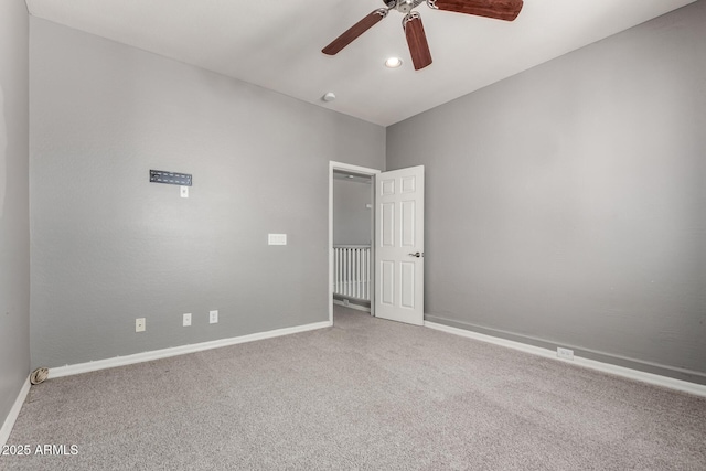 carpeted empty room featuring ceiling fan