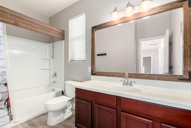 full bathroom featuring vanity, bathing tub / shower combination, and toilet