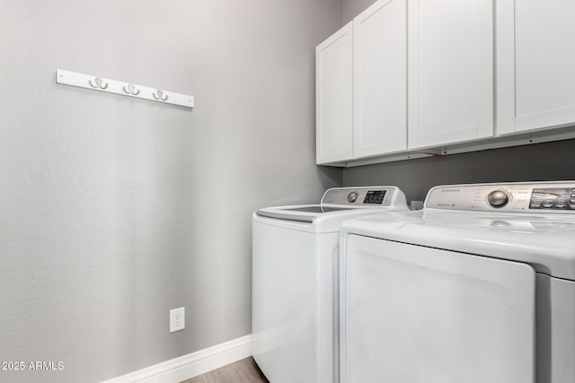 laundry area featuring independent washer and dryer and cabinets