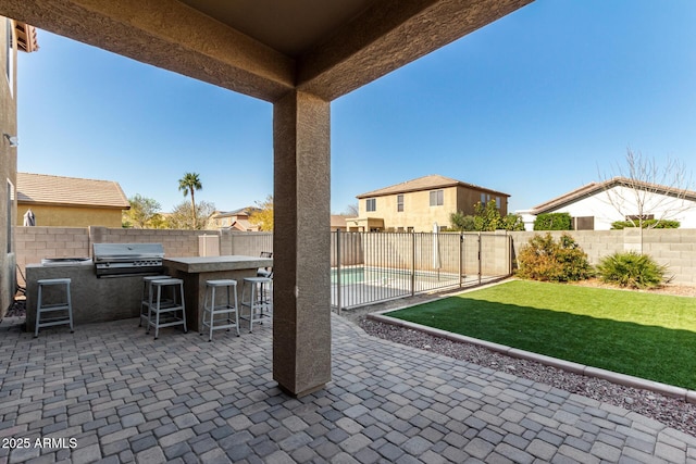 view of patio / terrace featuring area for grilling, an outdoor kitchen, and exterior bar