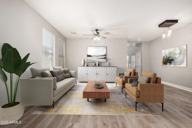 living room with ceiling fan and wood-type flooring