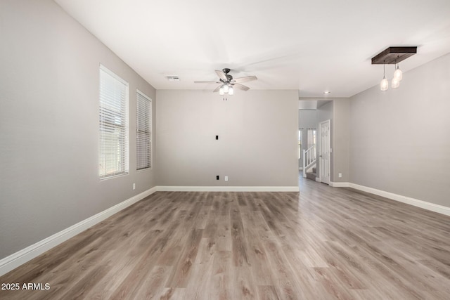 empty room with hardwood / wood-style flooring and ceiling fan