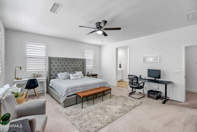 19736 W Turney Ave, Litchfield Park, AZ 85340 - carpeted bedroom with a desk, baseboards, ensuite bath, and a ceiling fan