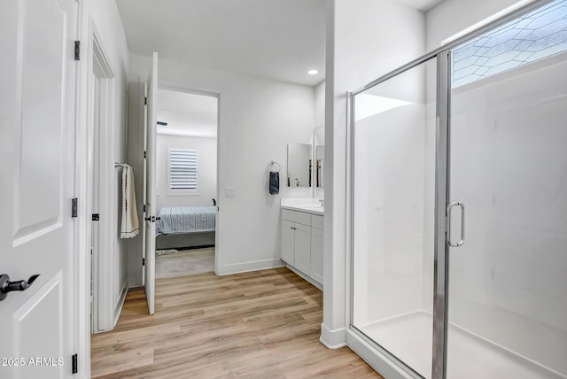 19736 W Turney Ave, Litchfield Park, AZ 85340 - bathroom featuring wood finished floors, a stall shower, vanity, ensuite bathroom, and recessed lighting