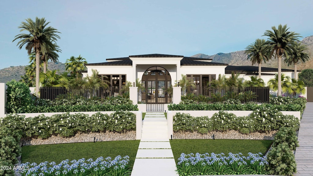 view of front of home featuring french doors, a mountain view, and a front yard