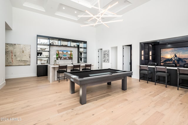 recreation room featuring coffered ceiling, billiards, light hardwood / wood-style floors, and a high ceiling