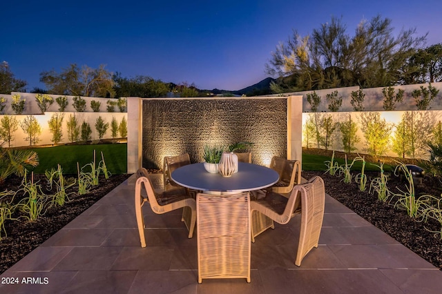 view of patio terrace at dusk