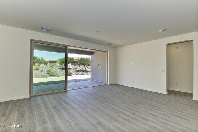 4320 Sawbuck Way, Wickenburg, AZ 85390 - spare room featuring visible vents, wood finished floors, and baseboards