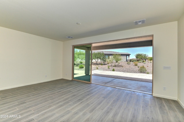 empty room with hardwood / wood-style floors