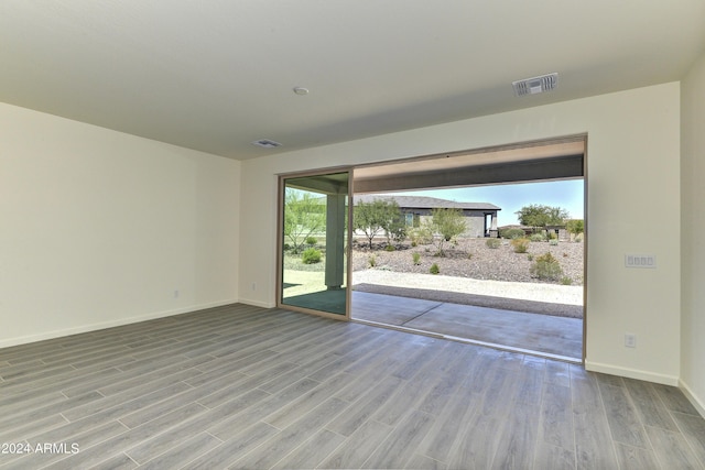 4320 Sawbuck Way, Wickenburg, AZ 85390 - spare room with visible vents, wood finished floors, and baseboards